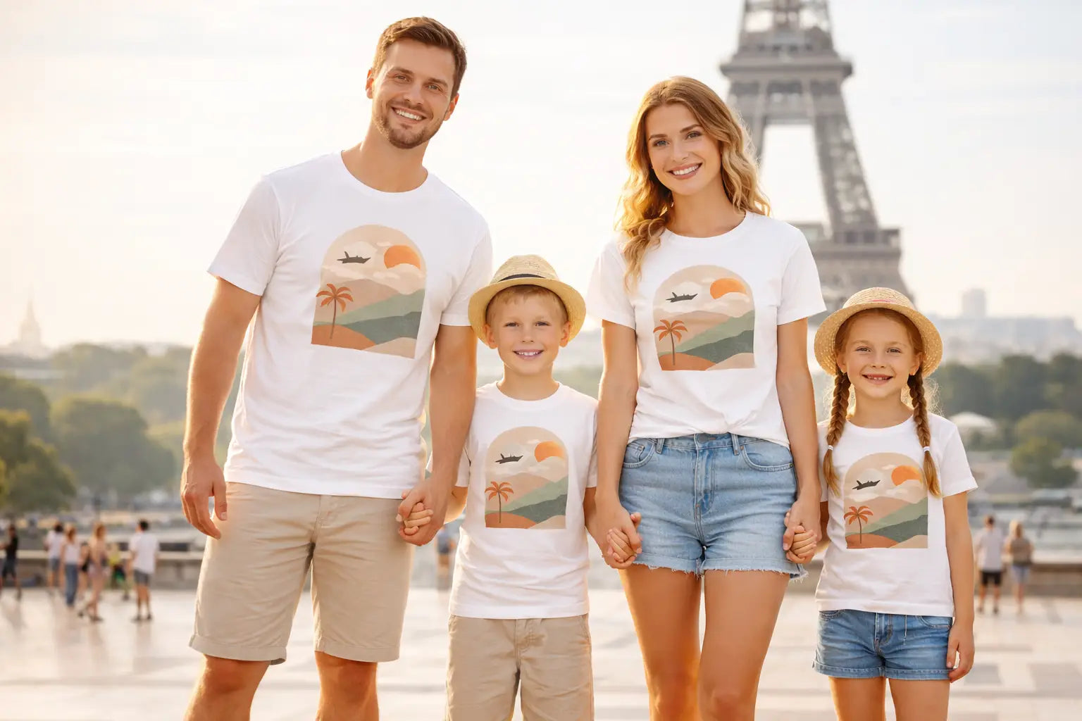 Family of four wearing matching t-shirts with a scenic design in front of the Eiffel Tower.